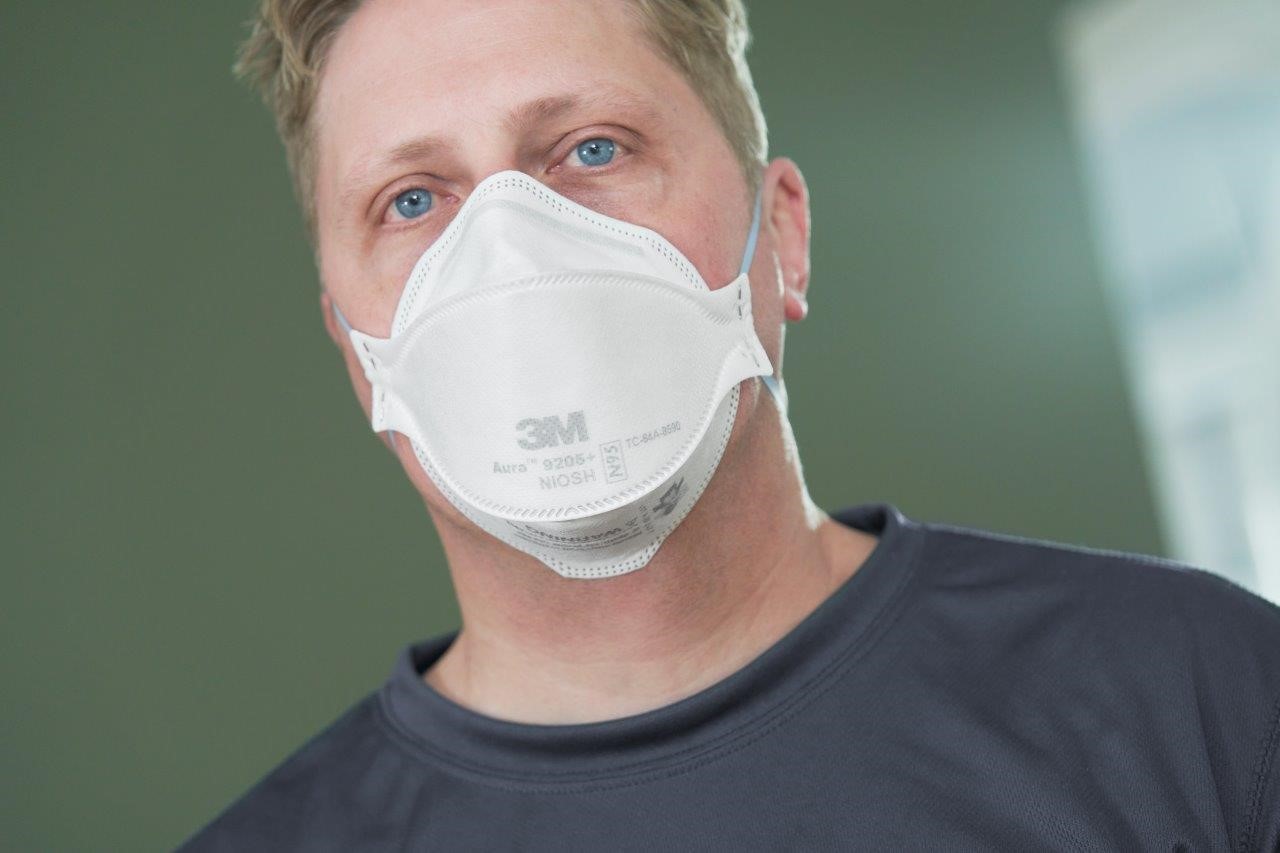 Headshot of a man wearing a respirator. 