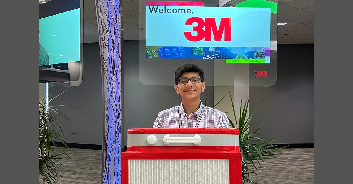 Shiven Taneja poses with a handmade Corsi-Rosenthal Box at 3M's global headquarters.